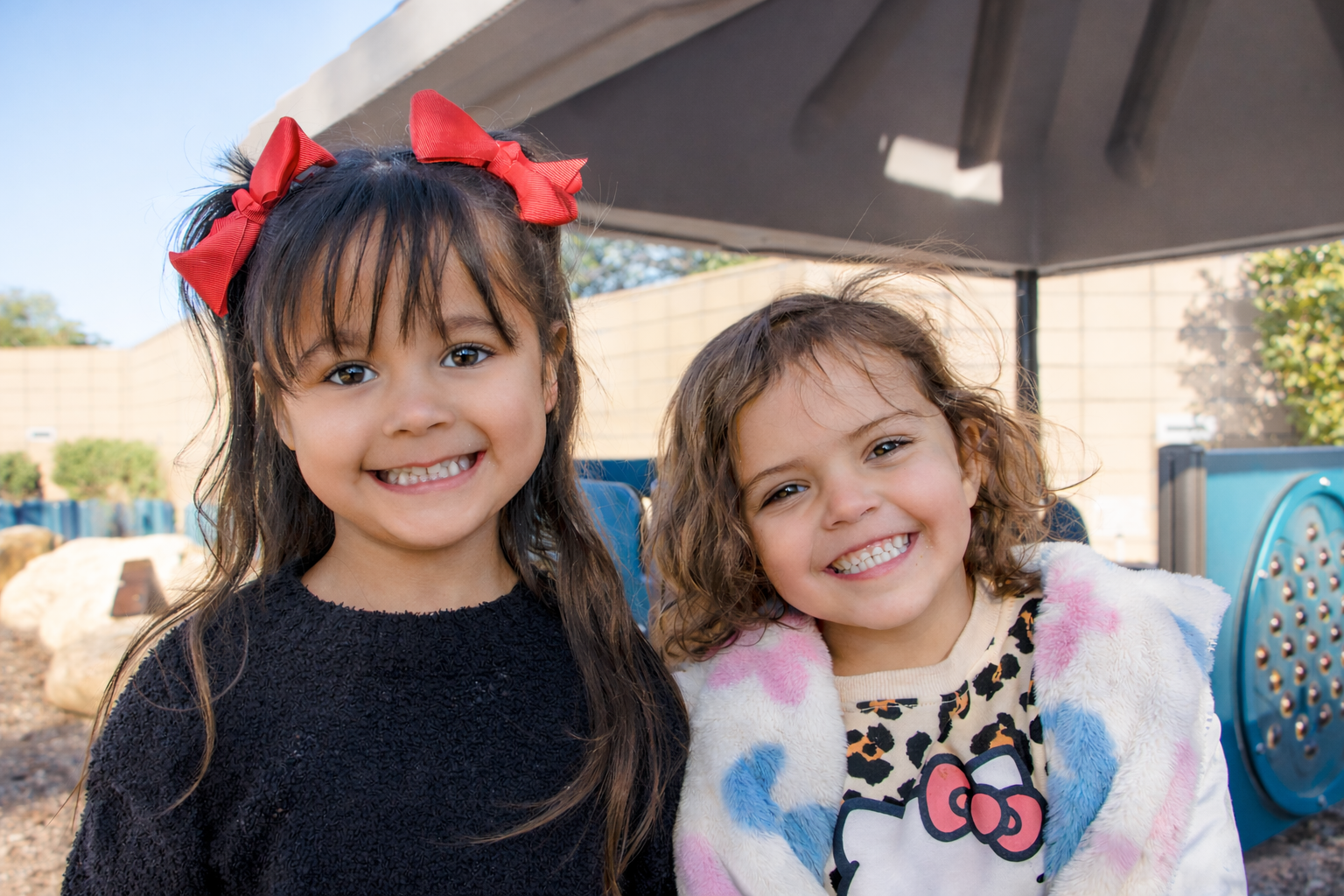 Emily Meschter Early Learning Center - two girls smiling on  the playground
