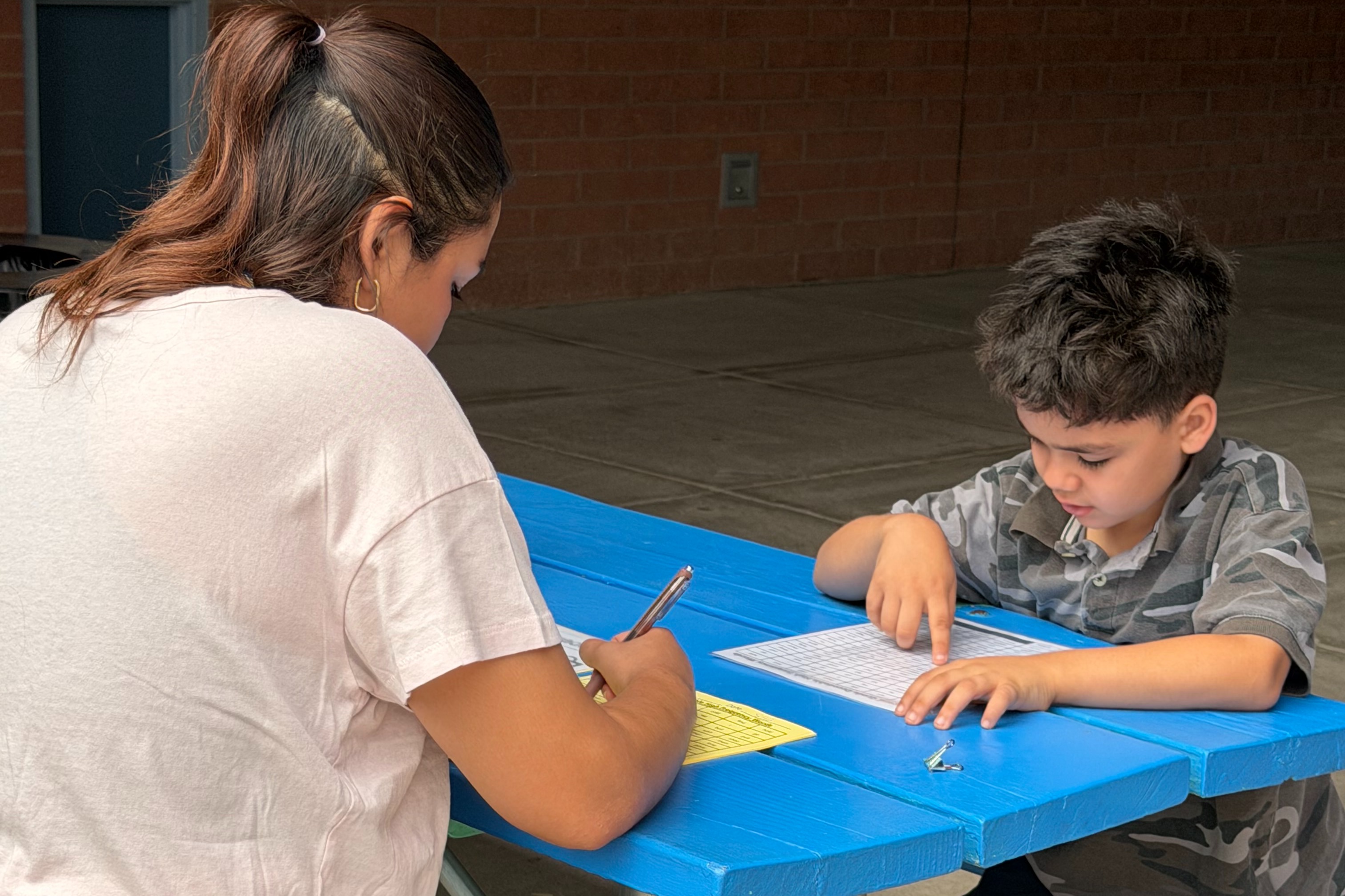 A Teacher Helping a 2nd Grader