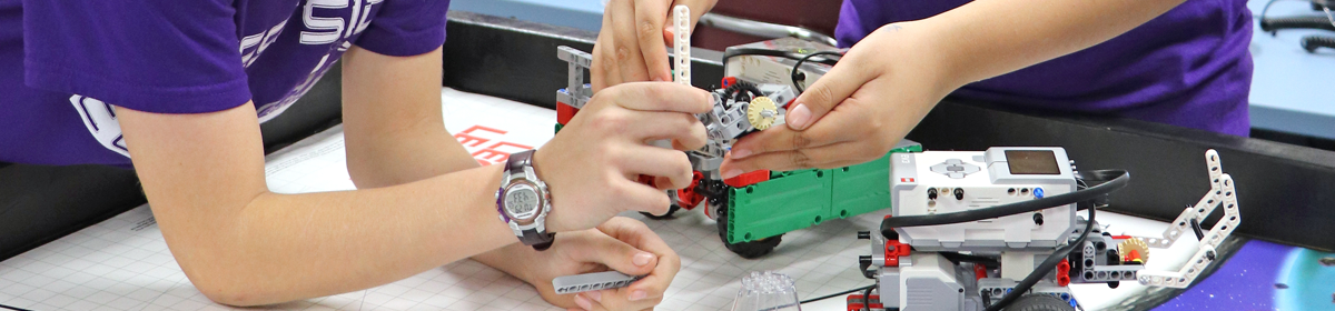 2 students working on robotics