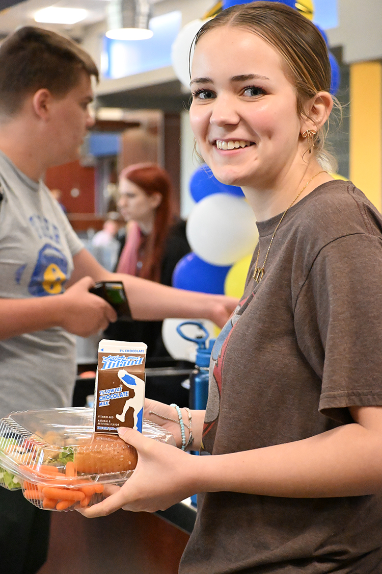 smiling girl  with lunch