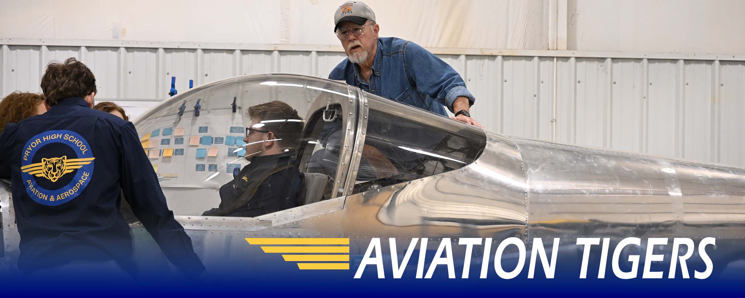 Aviation students mentor working on plane