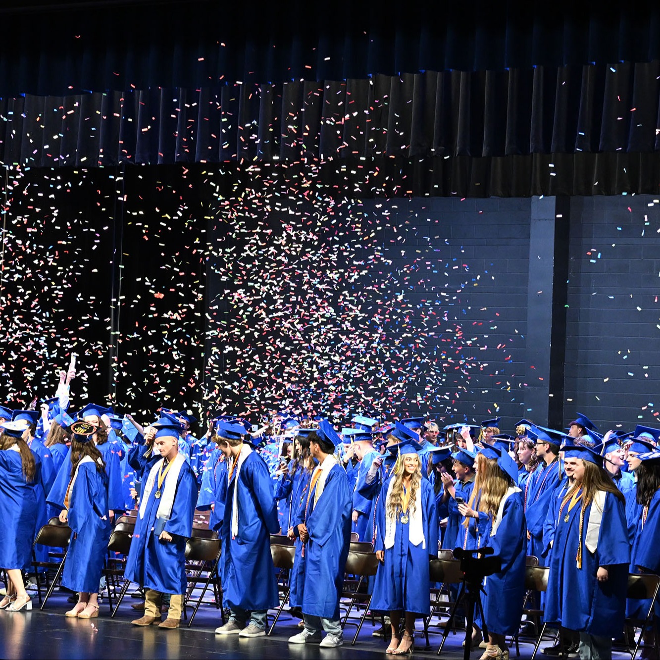 confetti flying over graduates