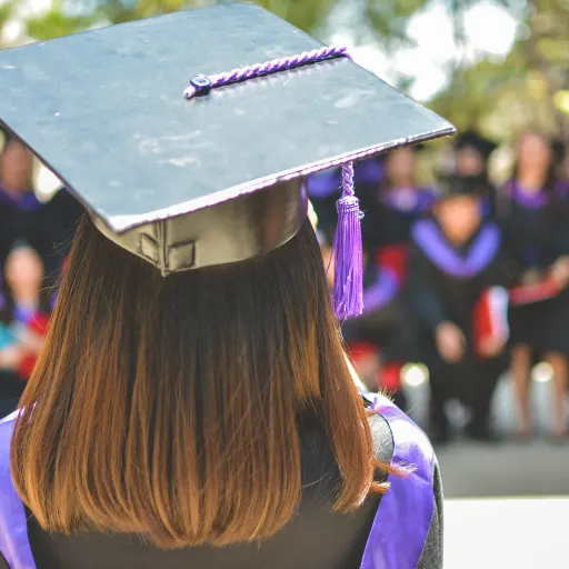 A woman wearing a graduation cap and gown