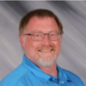 man with glasses wearing a blue shirt
