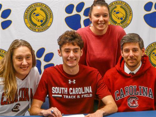 Athlete with family signing