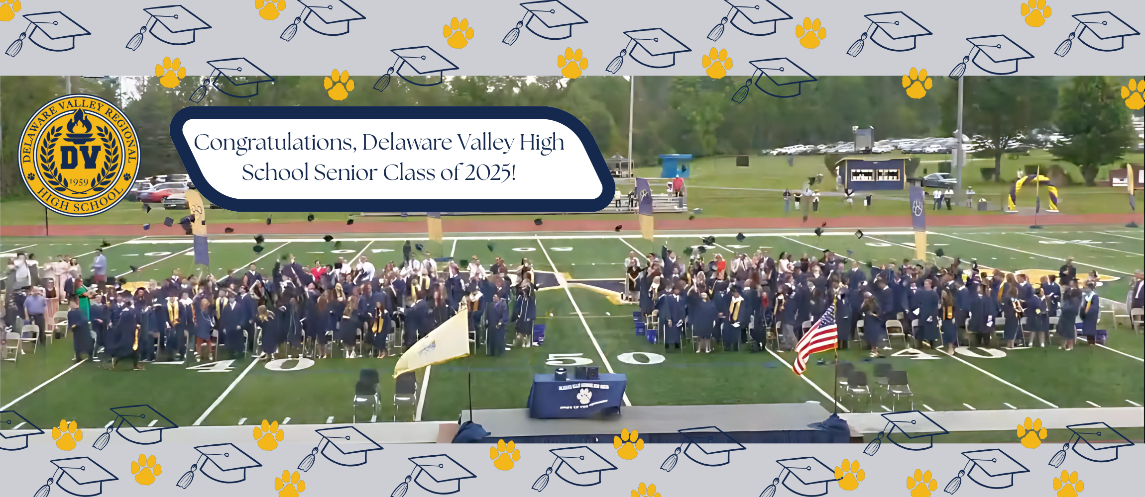 Del Val Senior Class students throwing graduation caps in the air in celebration.