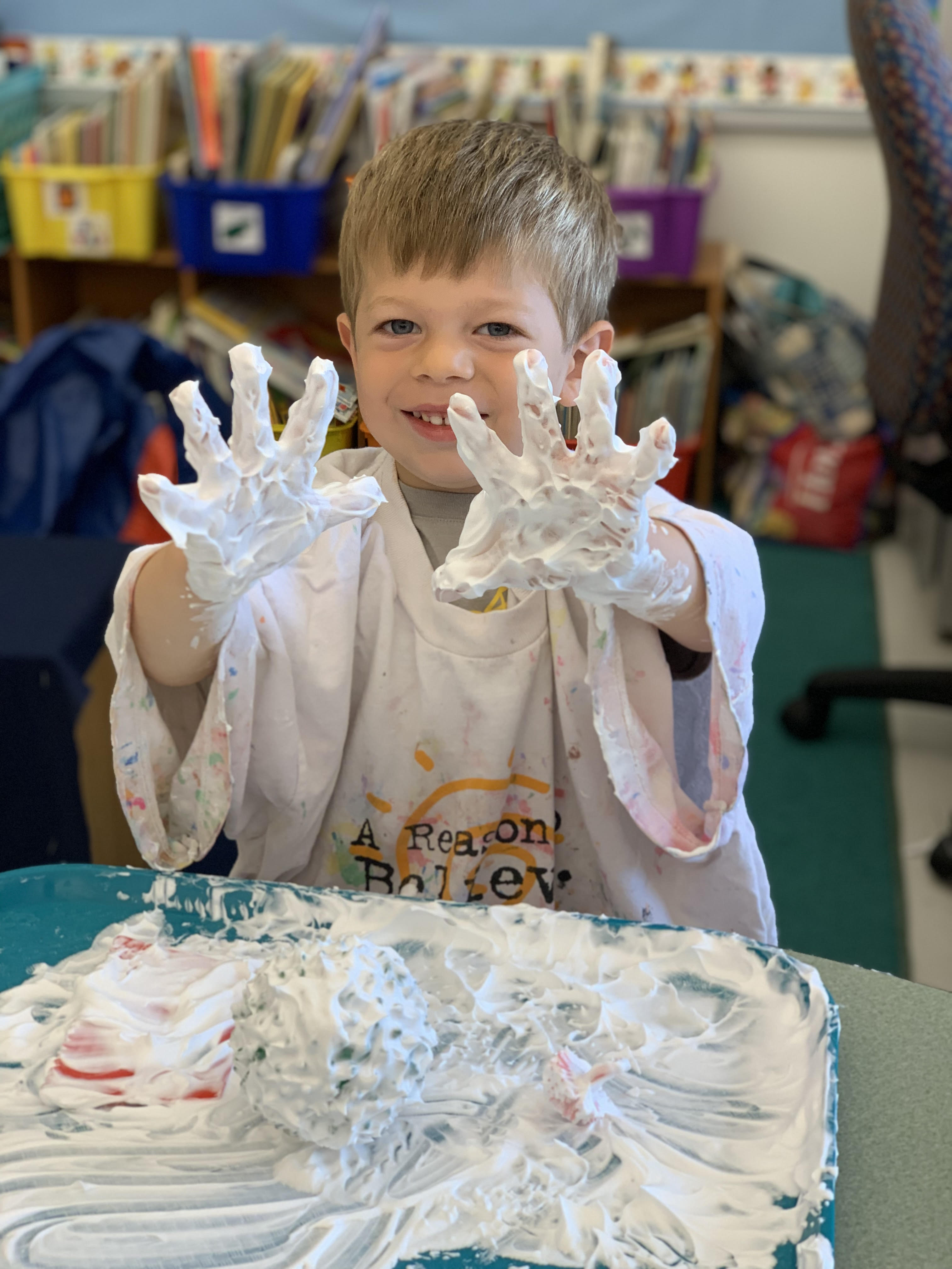 A photo of a student playing with foam