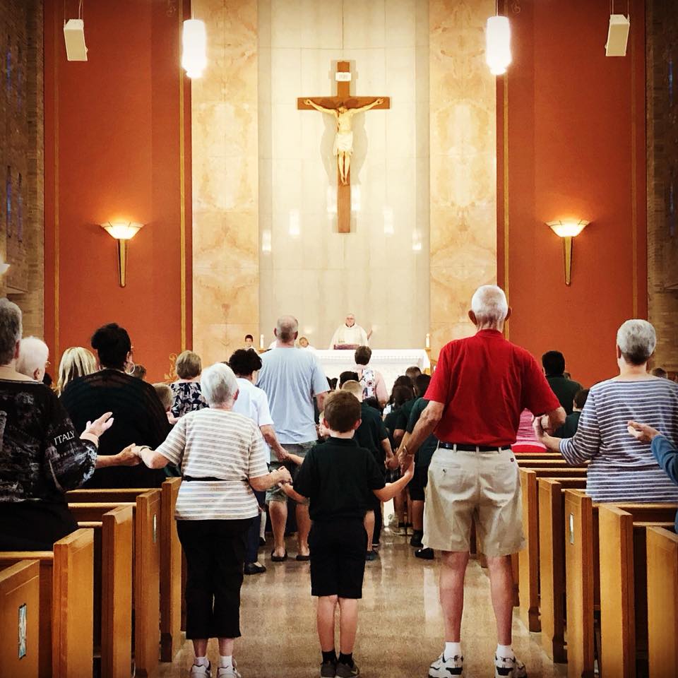 Group of People inside the Church while singing Our Father