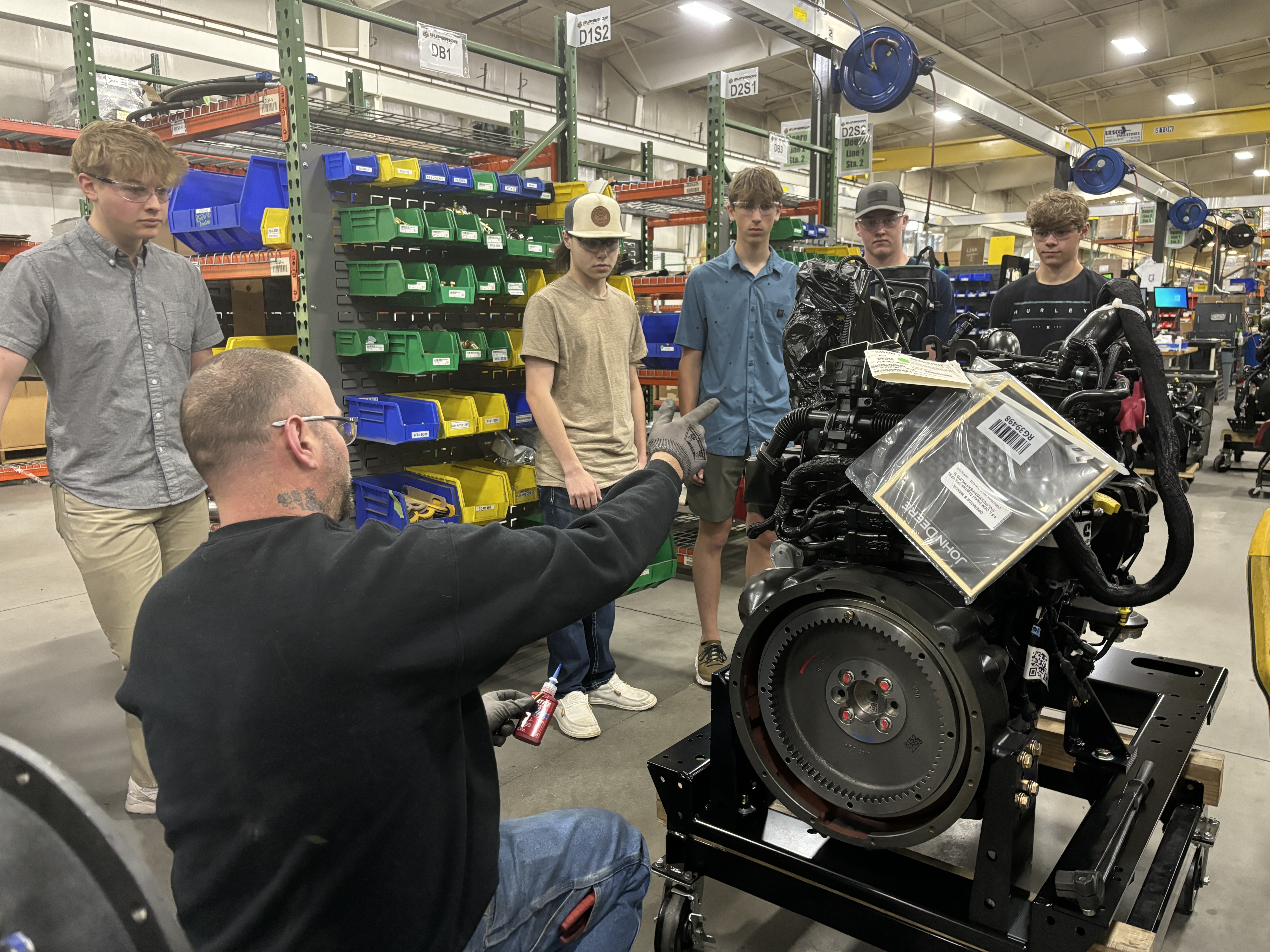 Students taking a company tour at a manufacturing business.
