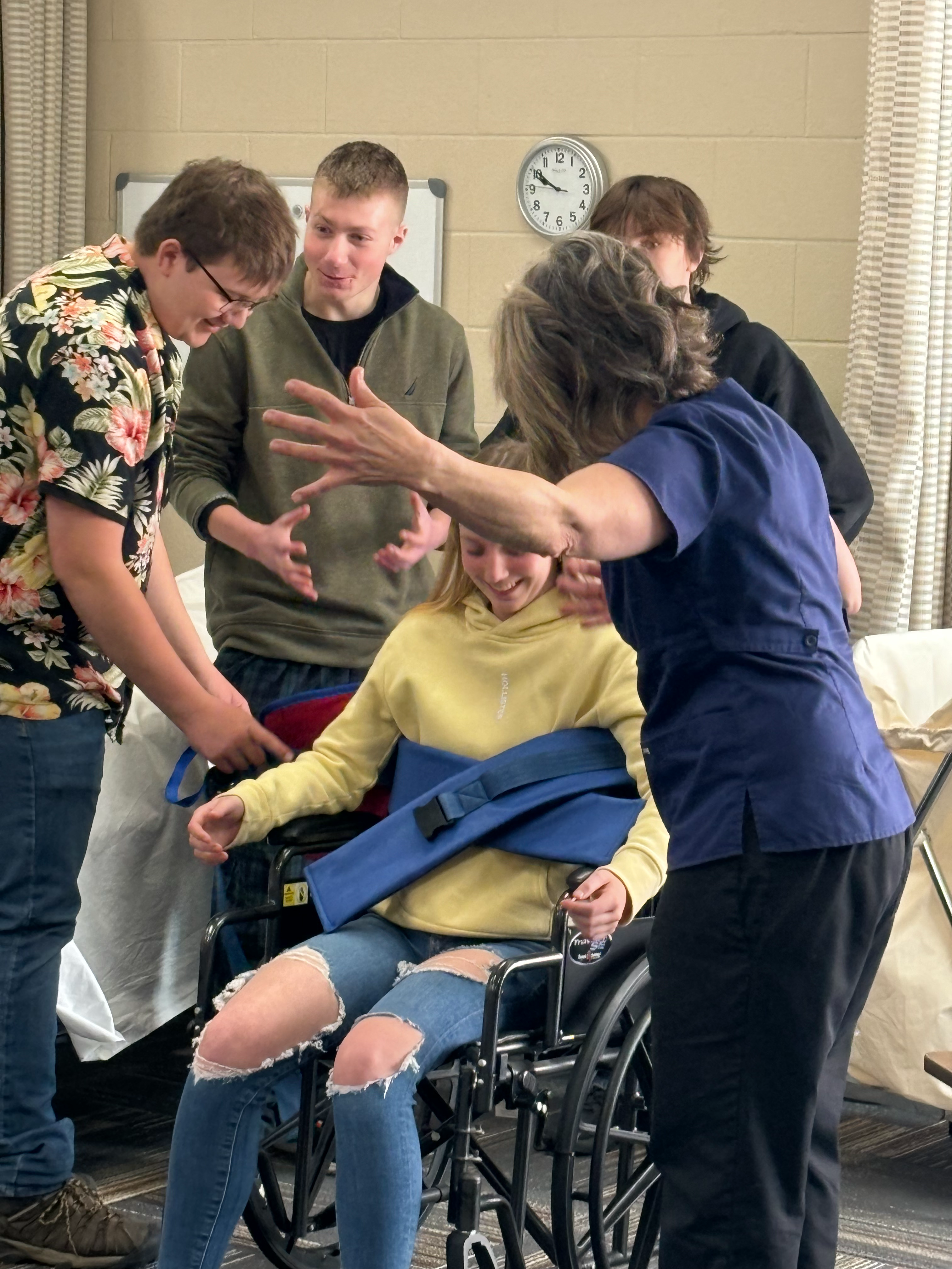 Youth Apprenticeship students working with a student in a wheelchair.