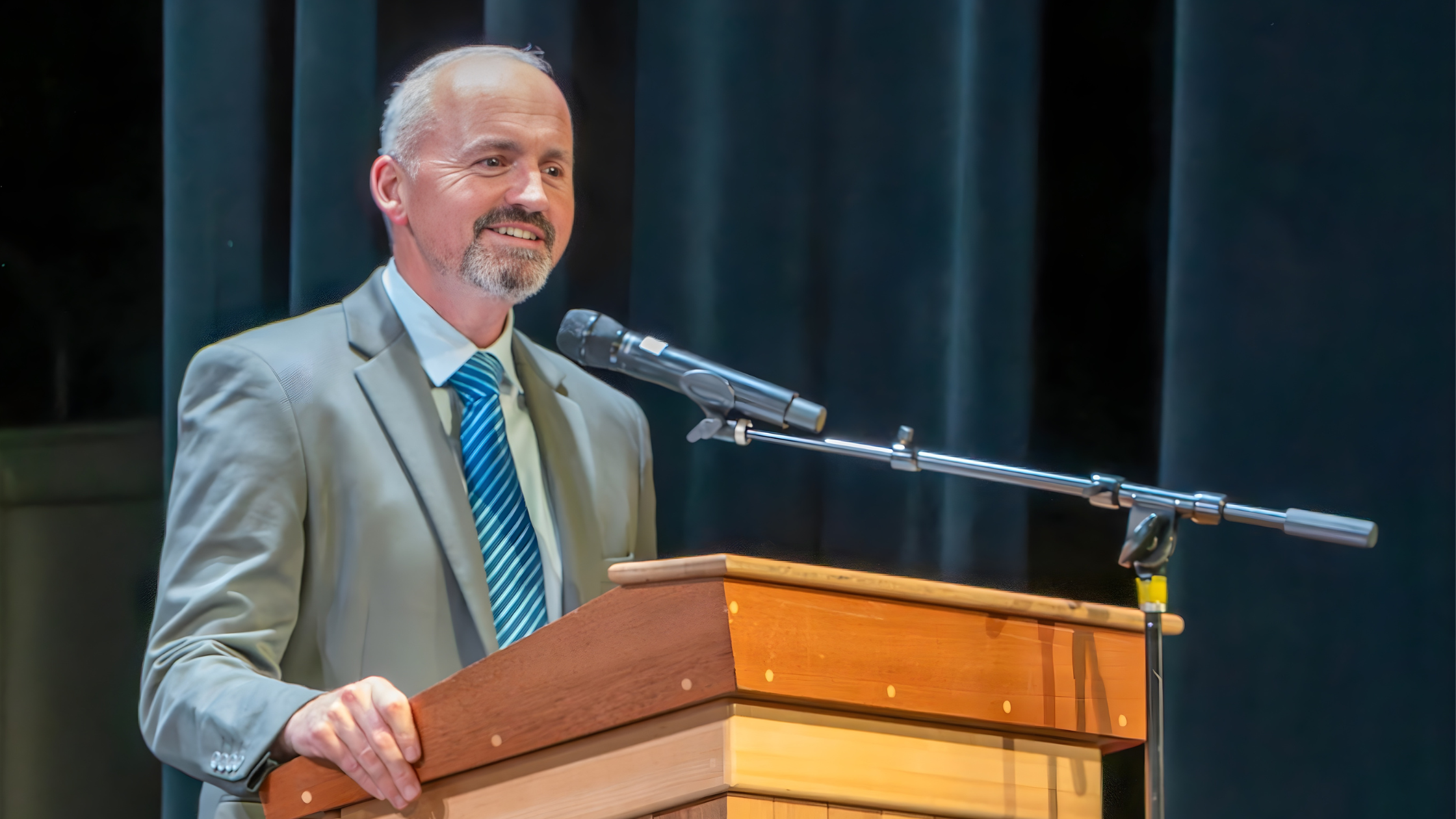 Superintendent Jason DeFalco stands at a podium.