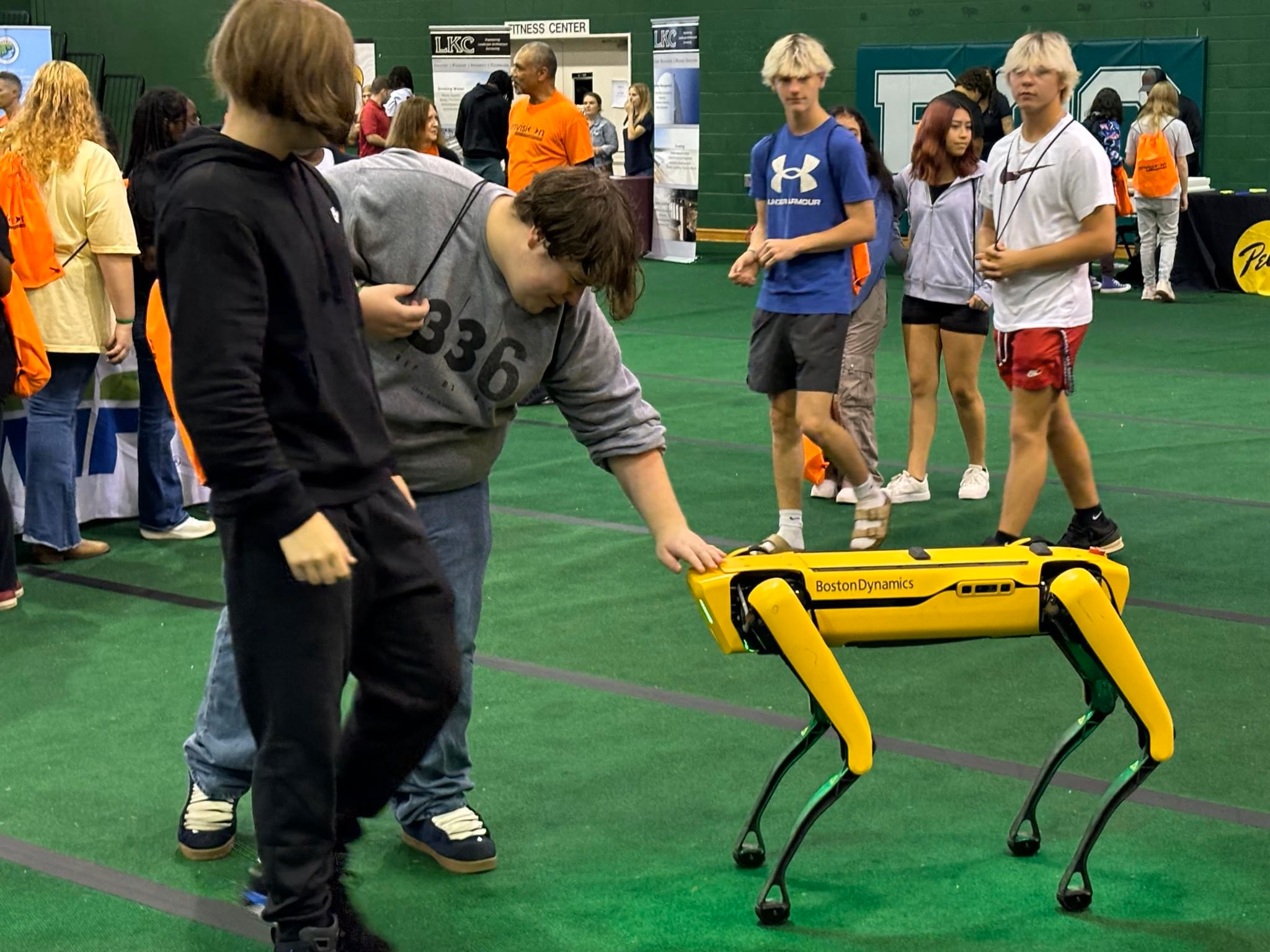 student petting robotic animal