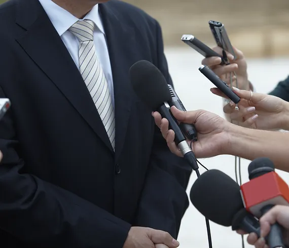 Media interview photograph of individual speaking with media
