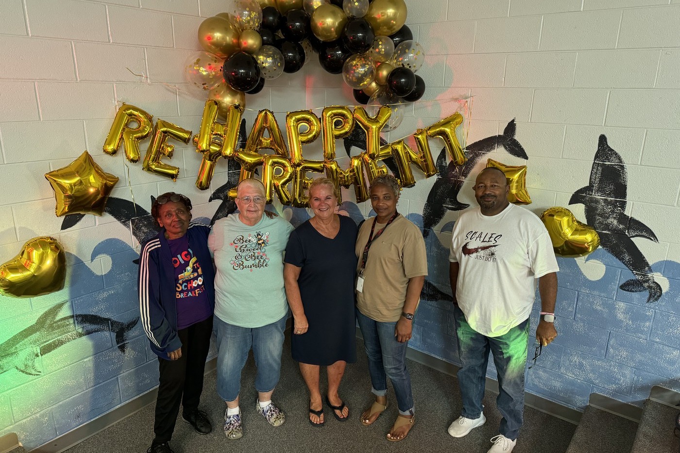 group of retirees with decorative balloons.