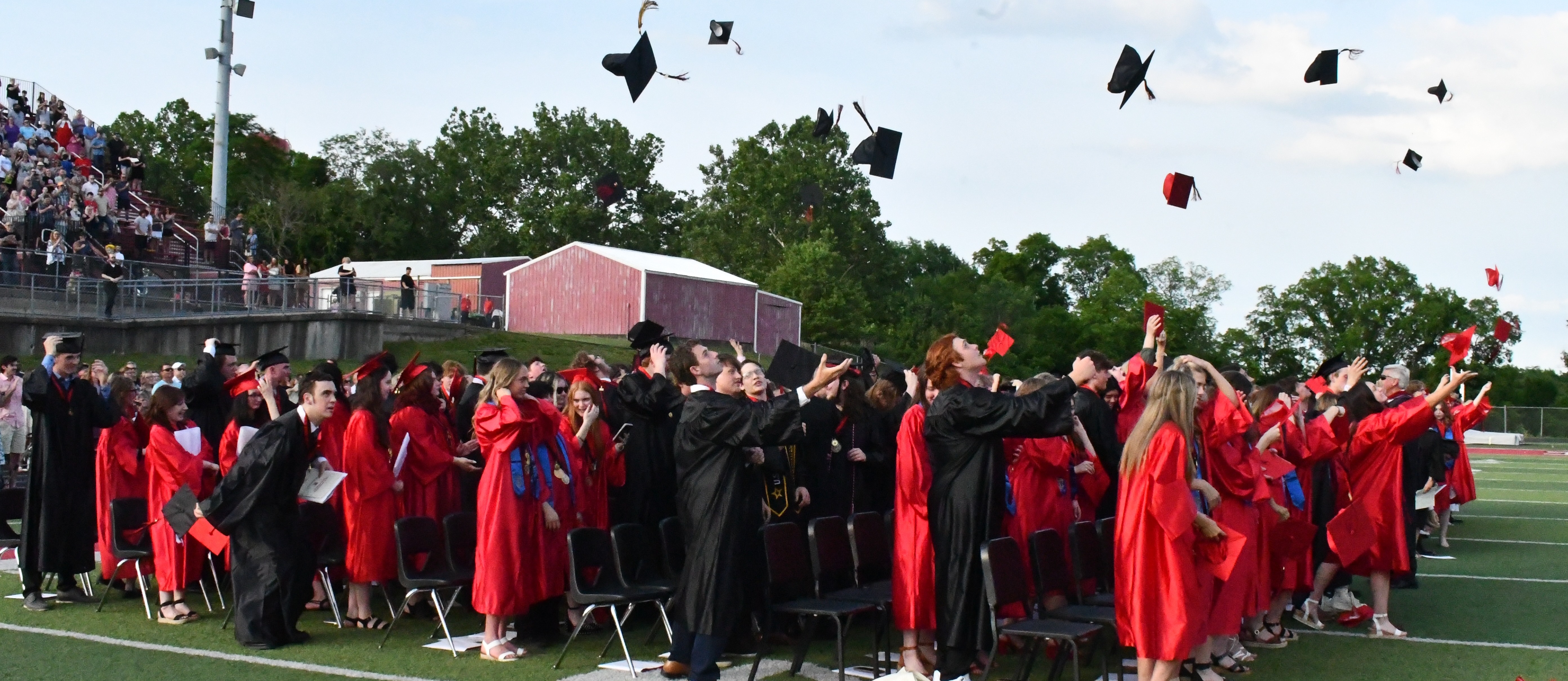 2024 graduates throw their caps into the air after the graduation ceremony