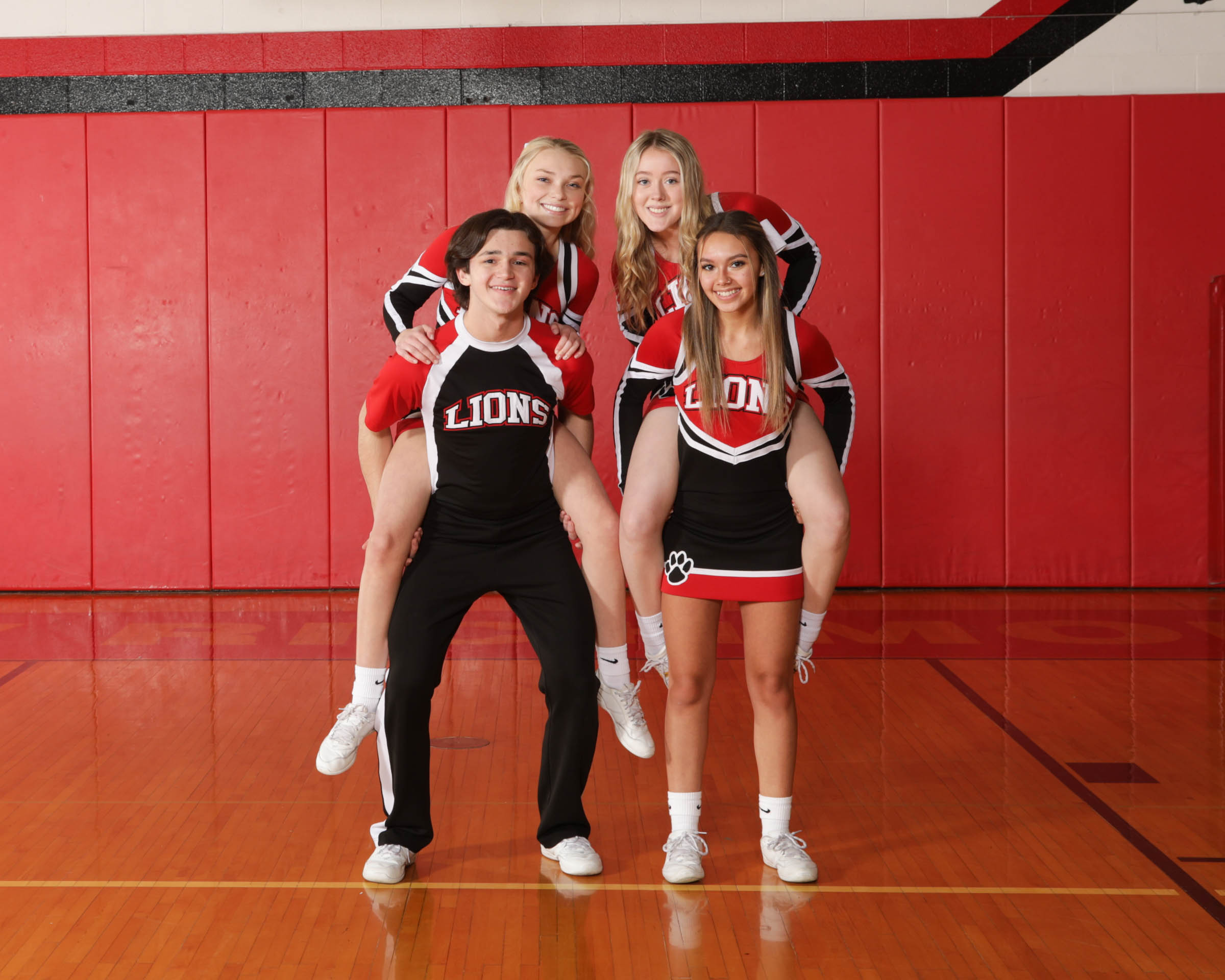 Four cheerleraders posing