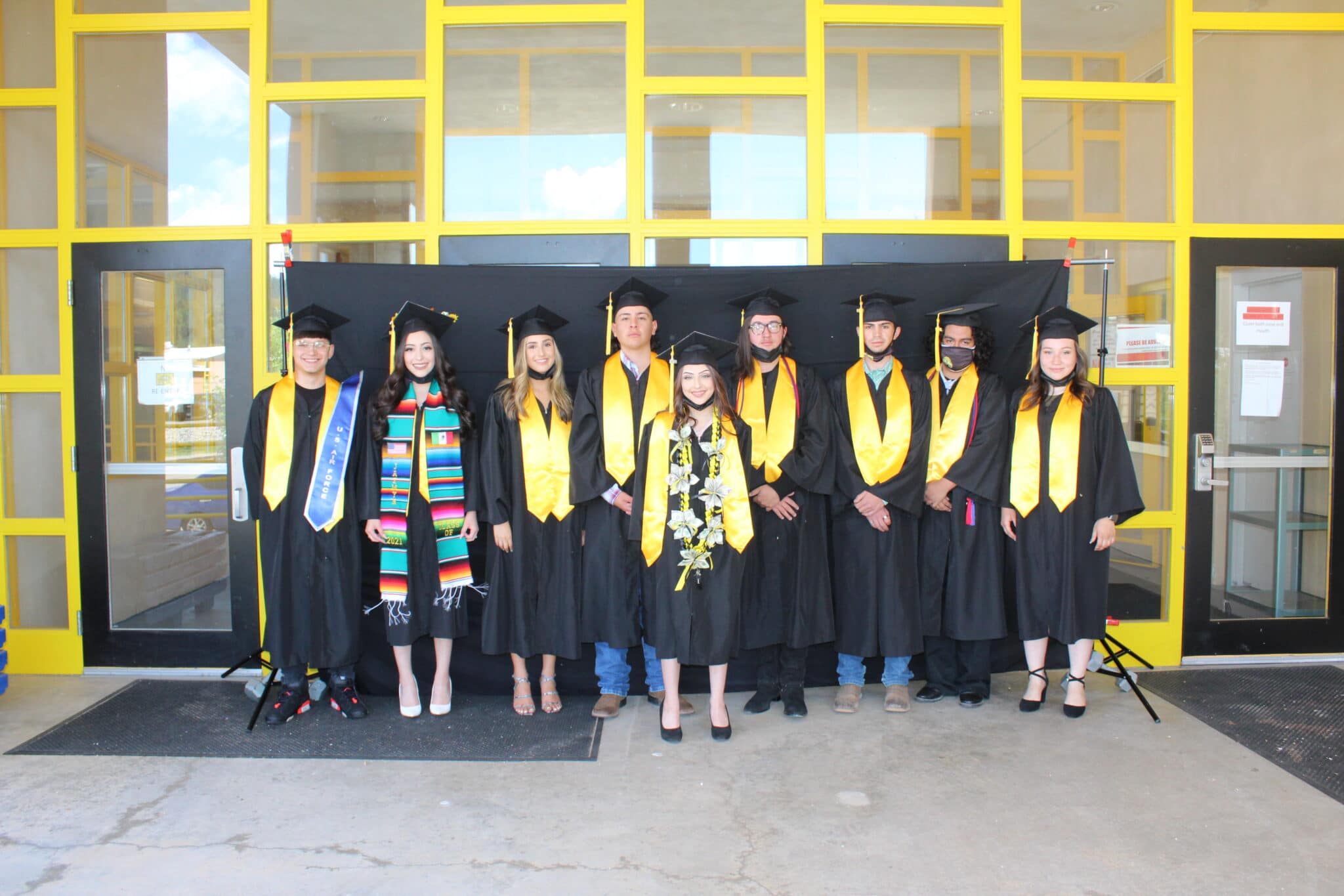 A group of students in graduation gowns and caps.