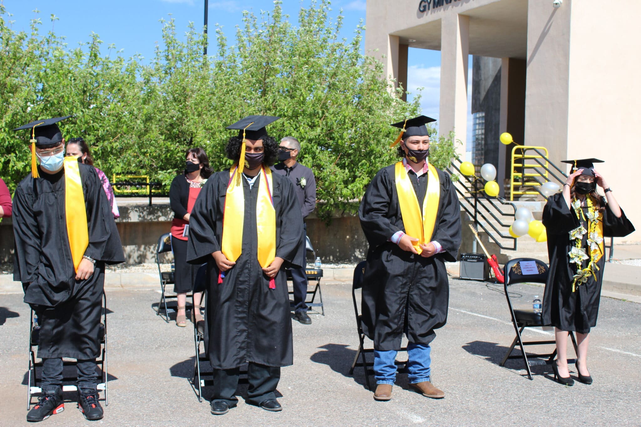 A group of students in graduation gowns and caps.