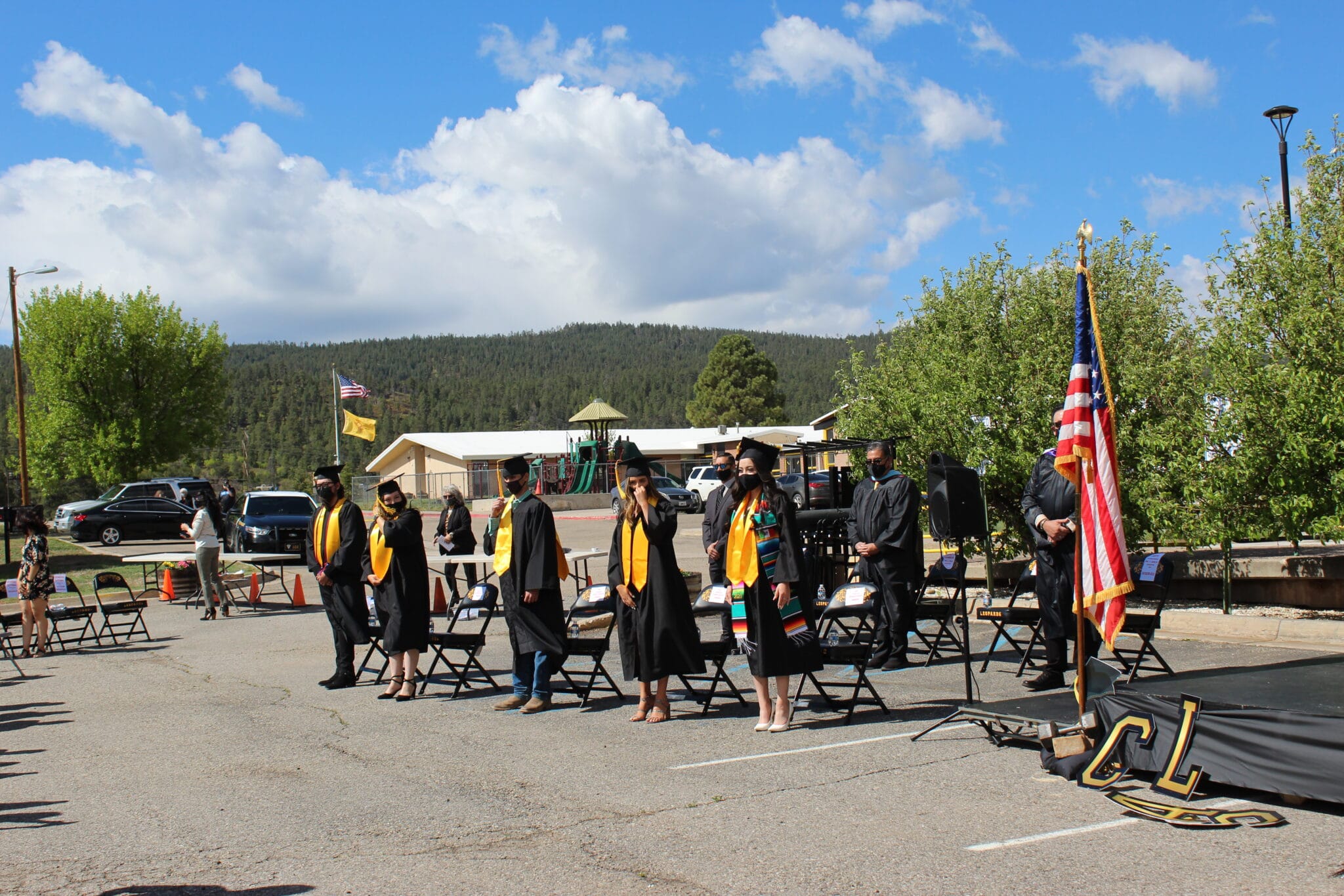 A group of students in graduation gowns and caps.