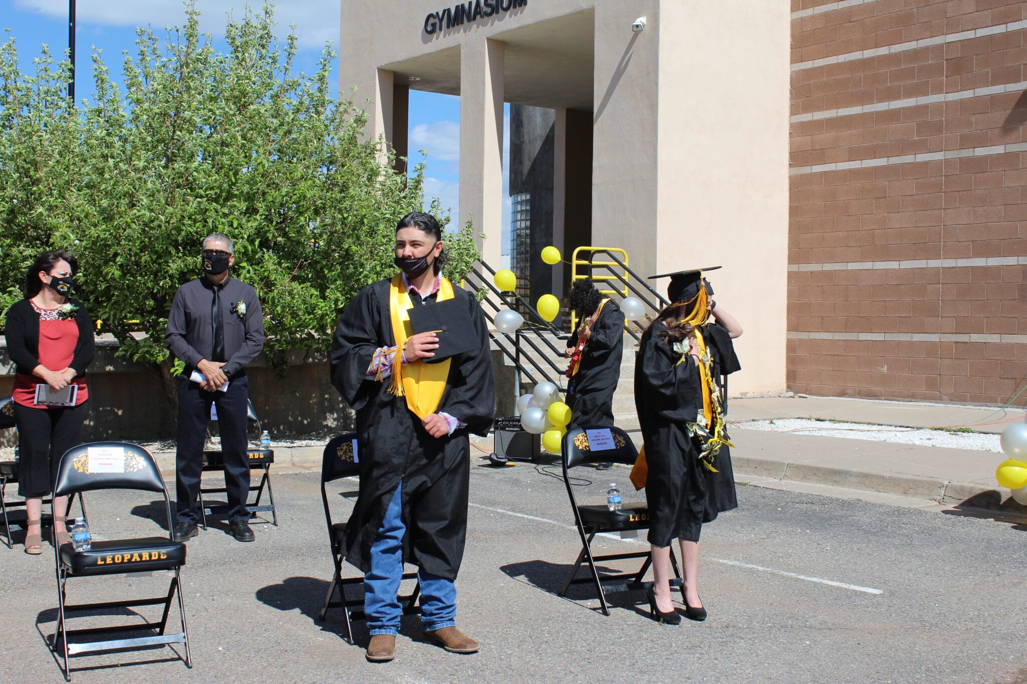 A group of students in graduation gowns and caps.