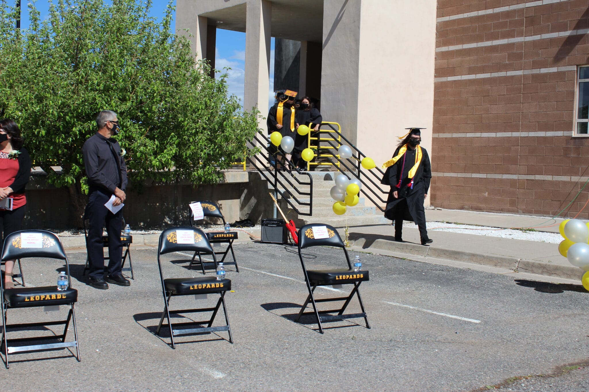 A group of students in graduation gowns and caps.