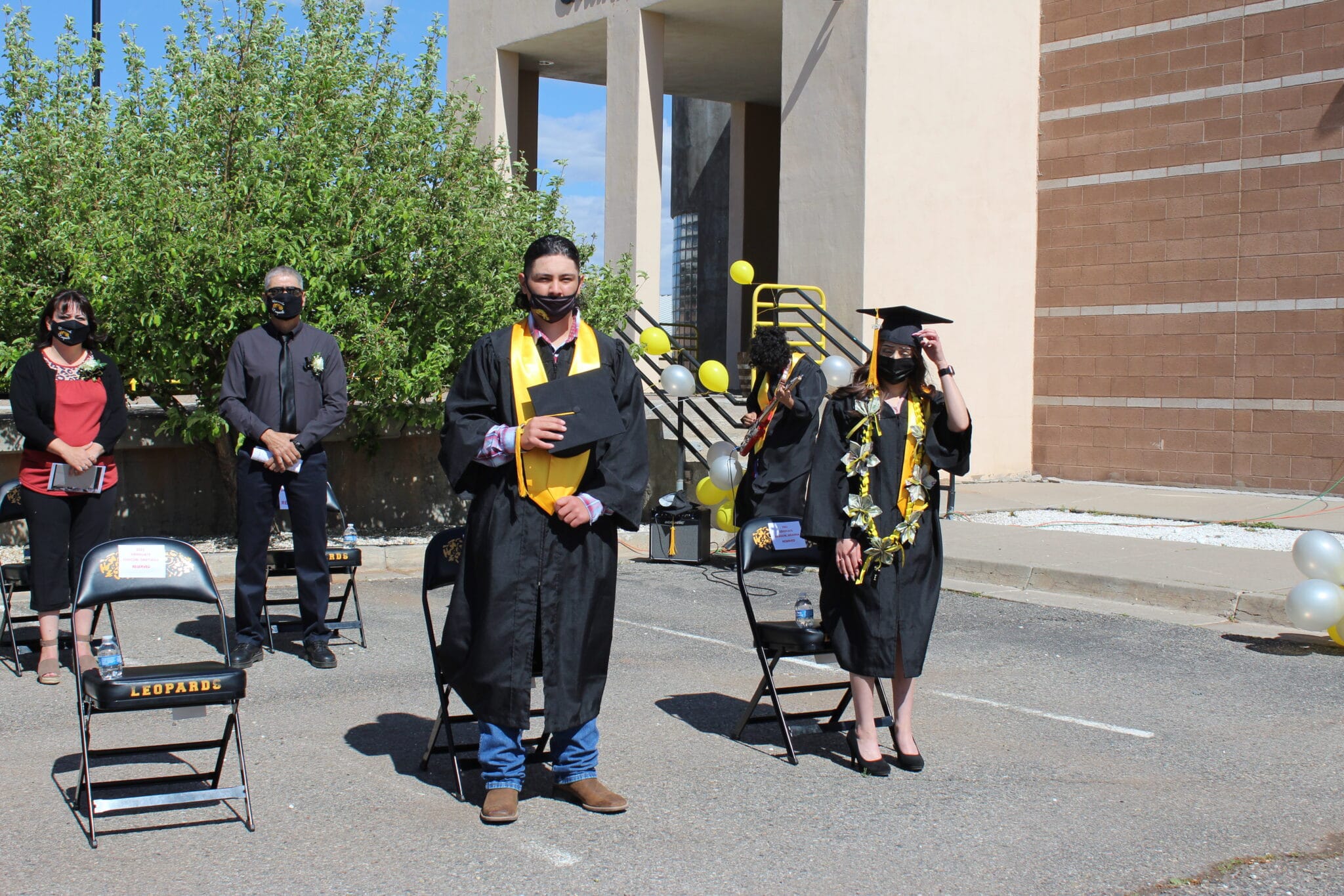 A group of students in graduation gowns and caps.