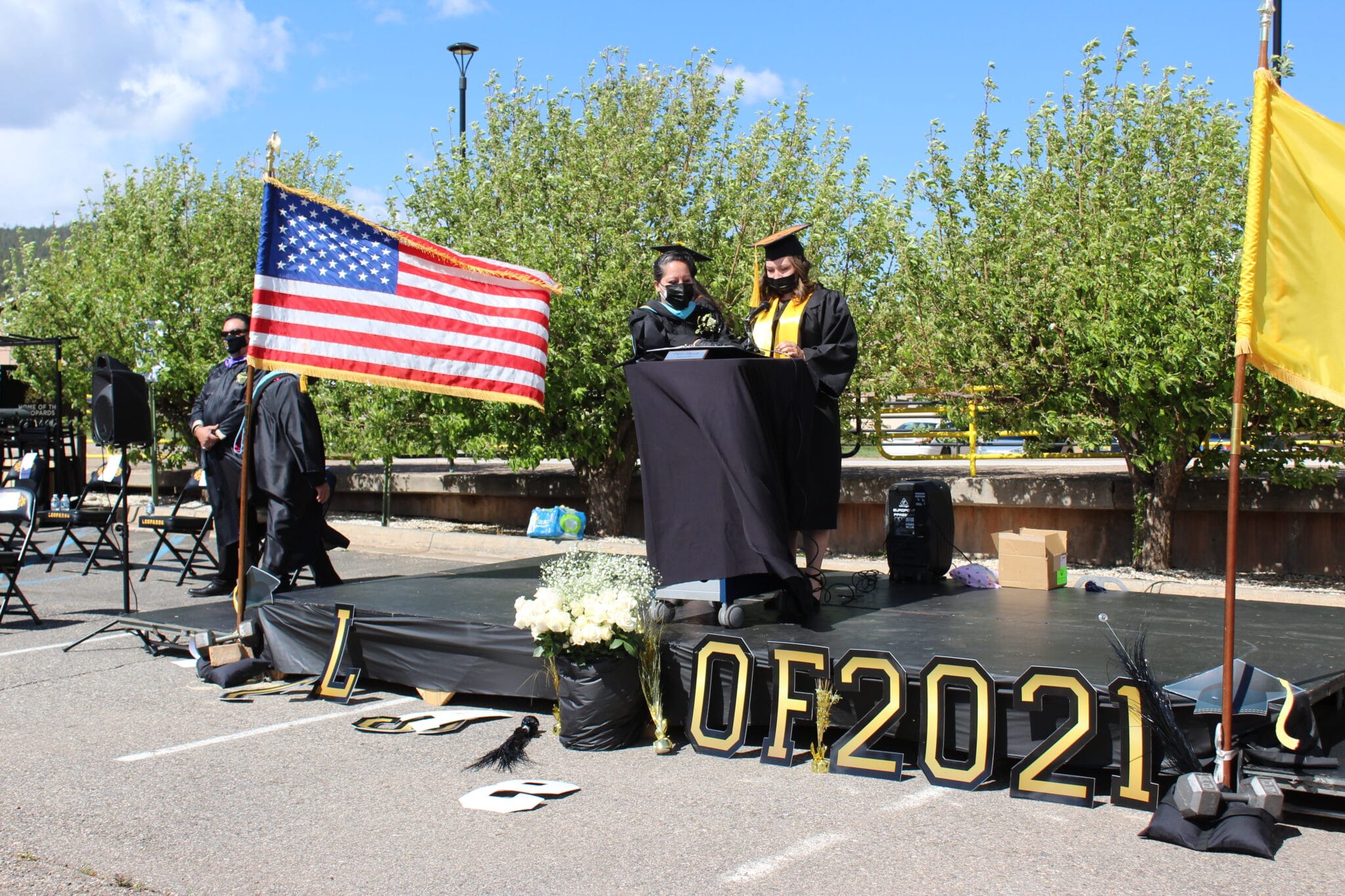 A group of students in graduation gowns and caps.