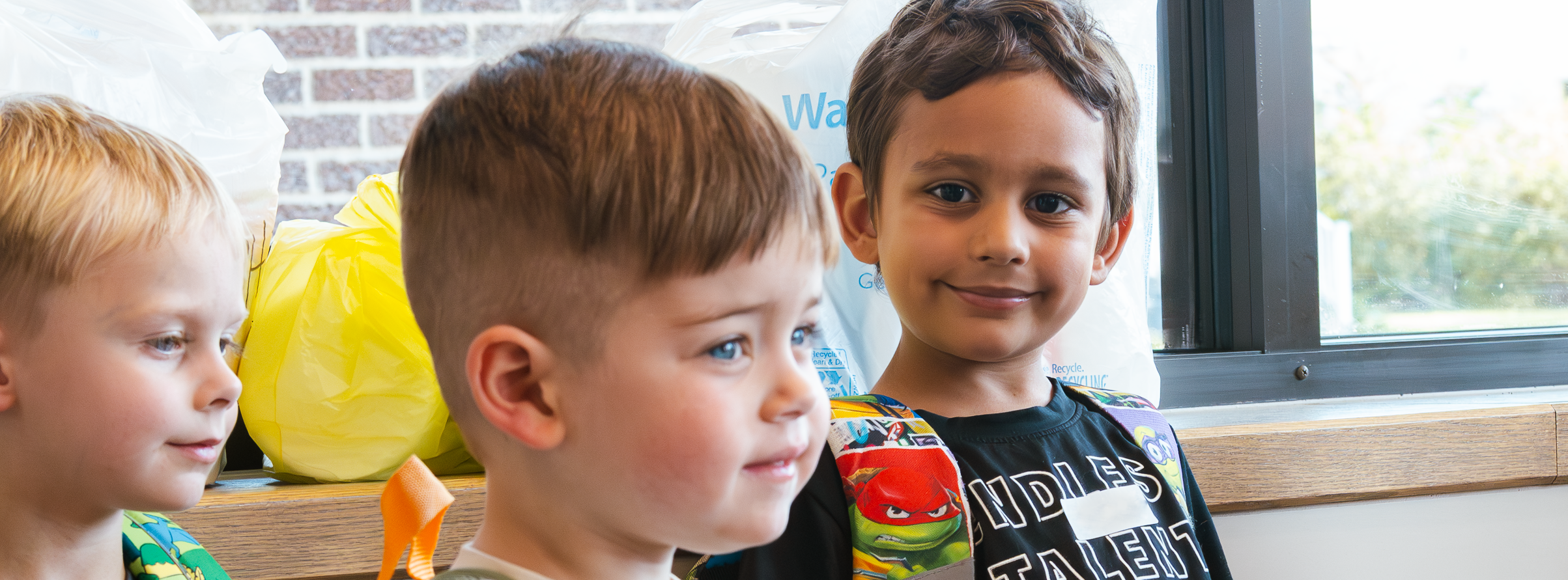 A group of boys wait in the vestibule before class begins at Kramer Preschool.