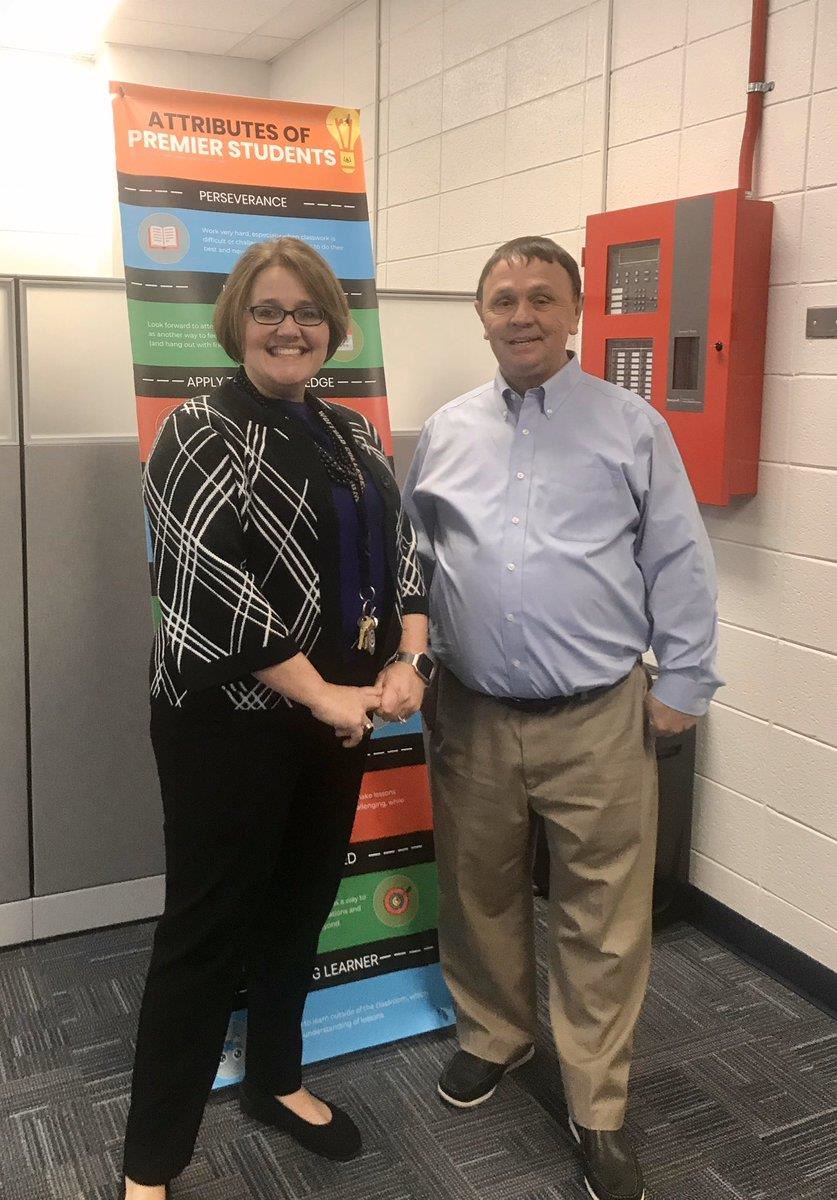 smiling and shaking hands principal for a day