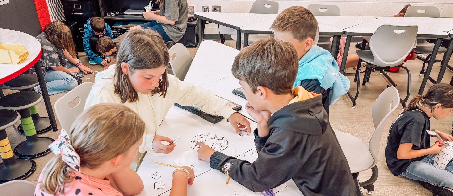 2 girls and 2 boys working on STEM activity
