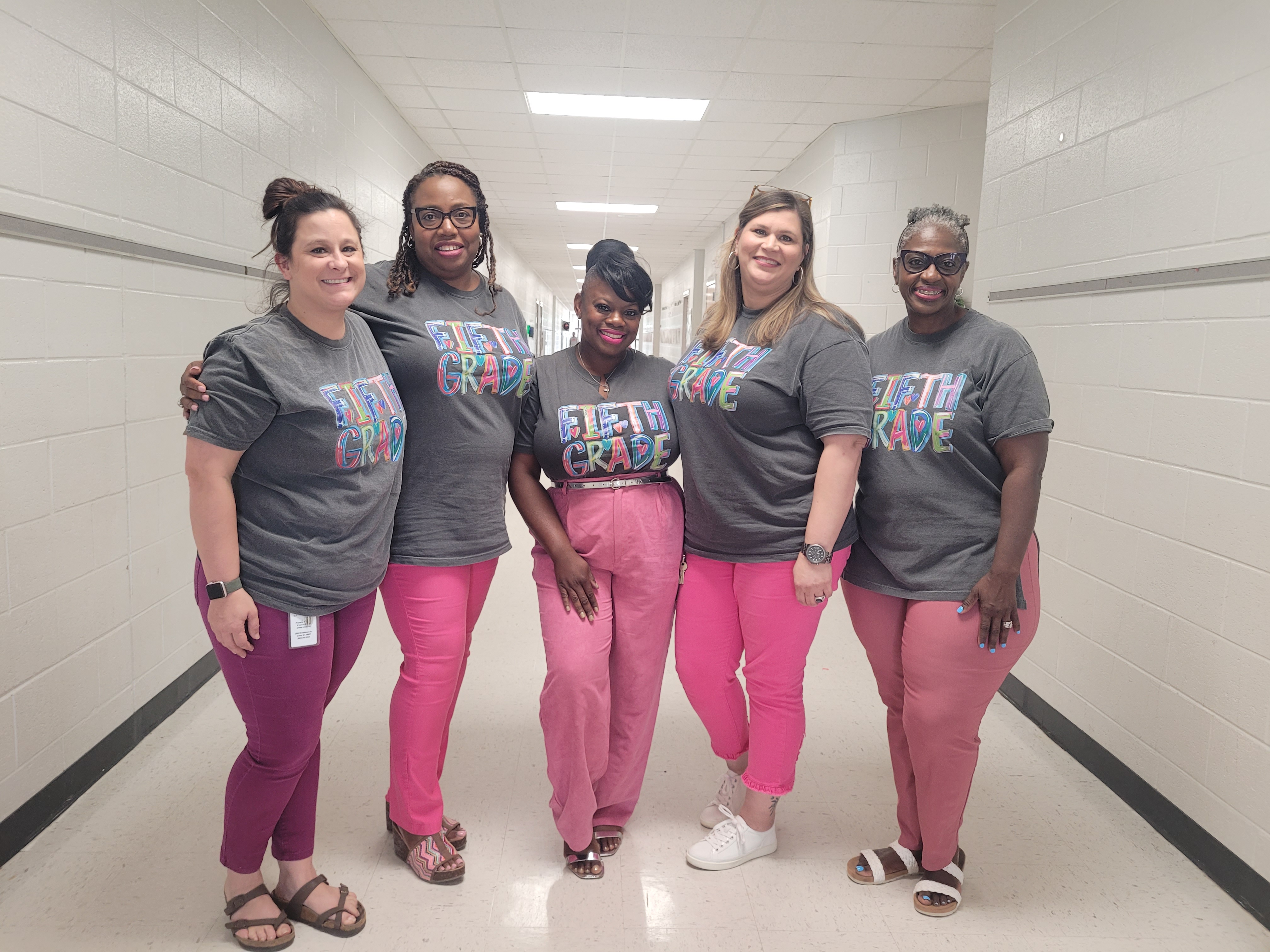 5 fifth grade teachers standing in hall.