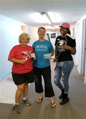 volunteers pose for photos