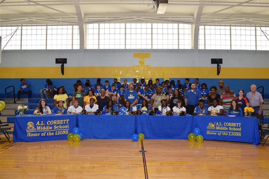 students standing in gymnasium Signing day cheerleaders commiting to cheering for ALCMS