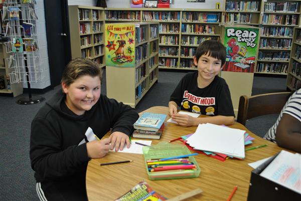 Two students writing a greeting card for veterans