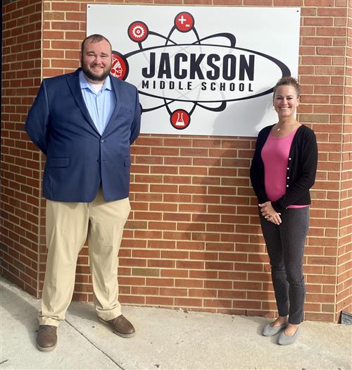 Pastor Dakota Windsor smiling next to school's principal