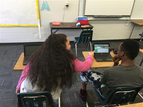 2 students working at desks