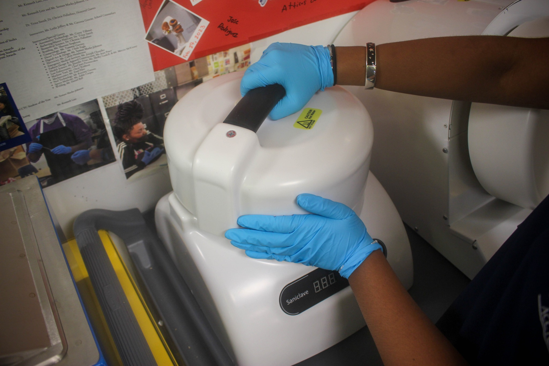 Student's hands working with an autoclave