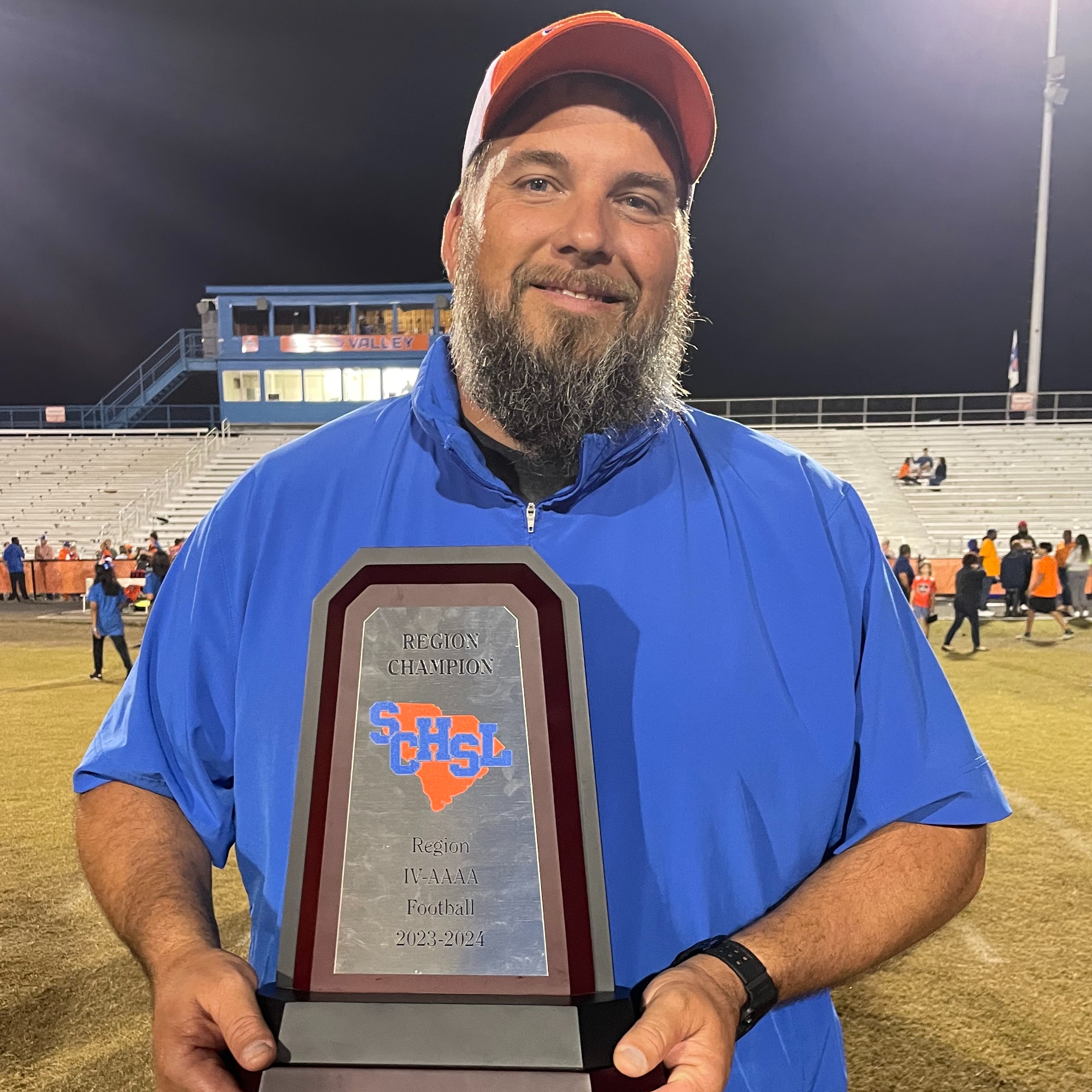 Coach Medlock Holding Region Trophy