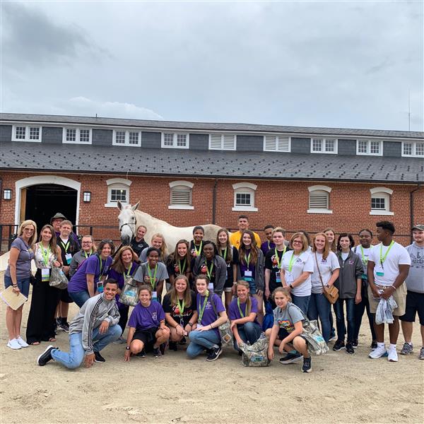 Students in front of horse stables