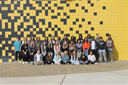 Group of students in front of pixel building