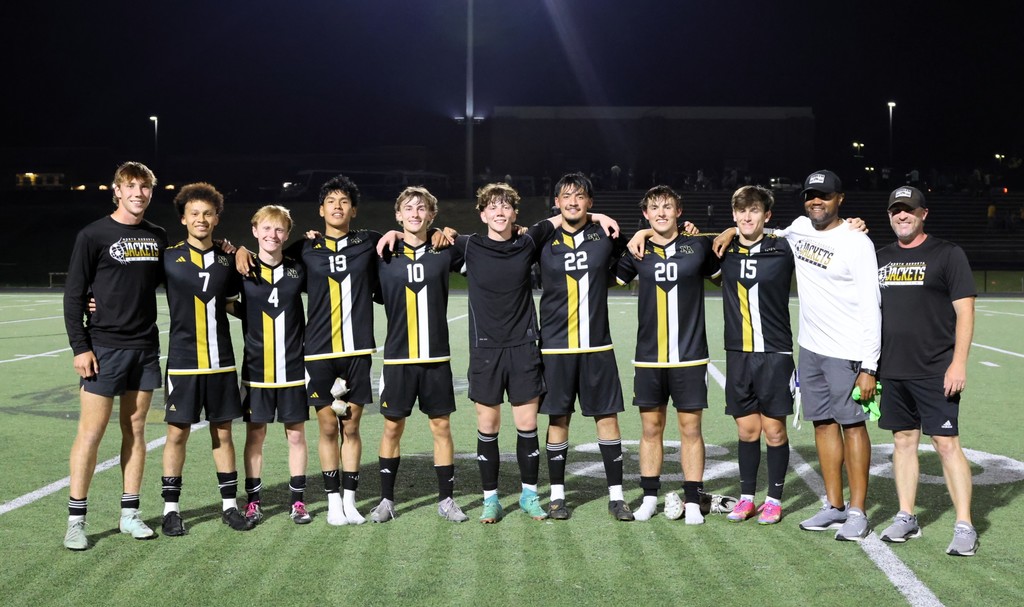 Boys Soccer team smiling together.