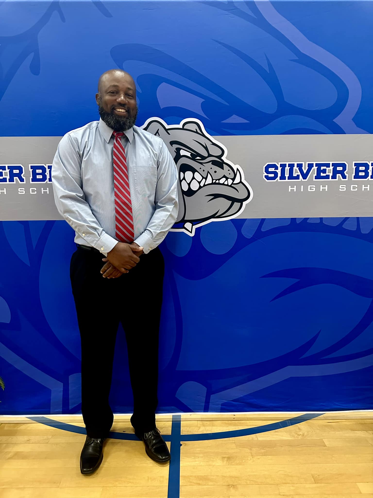 Athletic Director Phillip Strother standing in front of Silver Bluff Bulldog backdrop