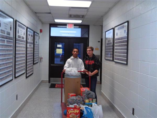 2 students with supermarket cart