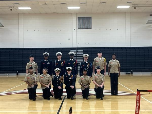 Military students posing with uniform at gym 