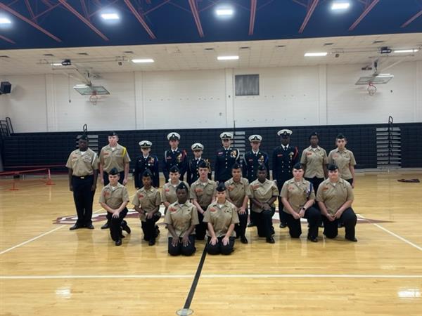 Military students posing with uniform at gym 