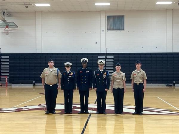 Military students posing with uniform at gym 