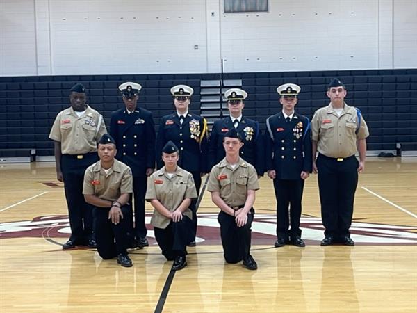 Military students posing with uniform at gym 