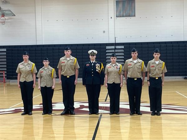 Military students posing with uniform at gym 