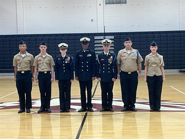 Military students posing with uniform at gym 