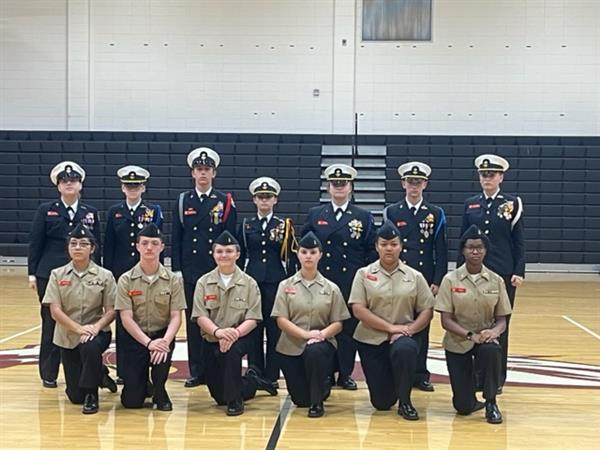 Military students posing with uniform at gym 